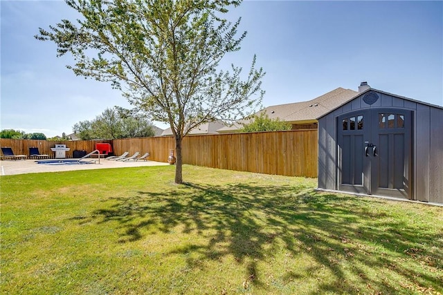 view of yard with a storage unit and a patio area