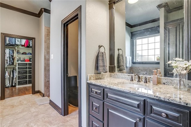 bathroom featuring a textured ceiling, vanity, and ornamental molding