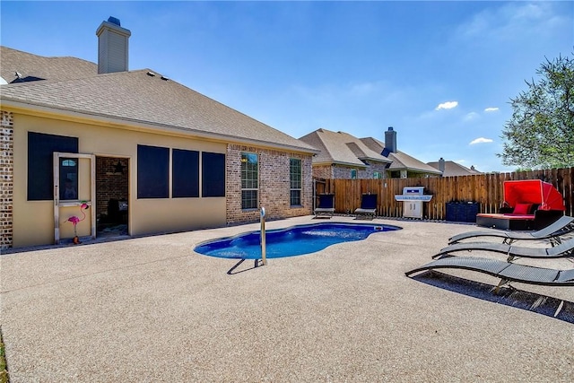 view of pool with a grill and a patio