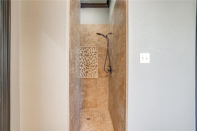 bathroom with a tile shower