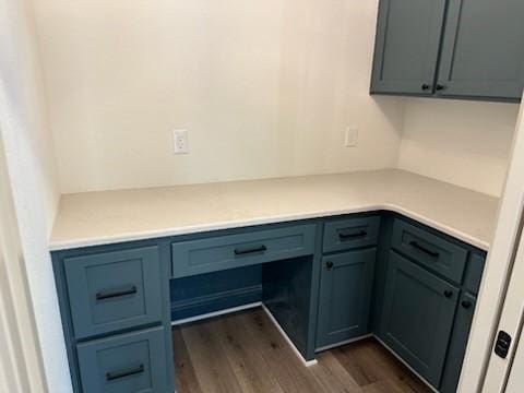 interior space with dark wood finished floors and built in desk