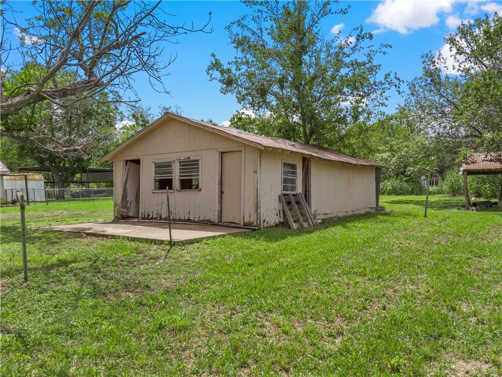 back of property featuring a yard