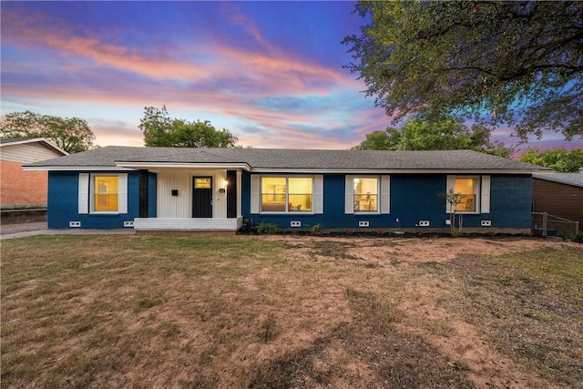 ranch-style home with a lawn