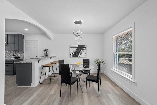 dining room with an inviting chandelier and light hardwood / wood-style flooring