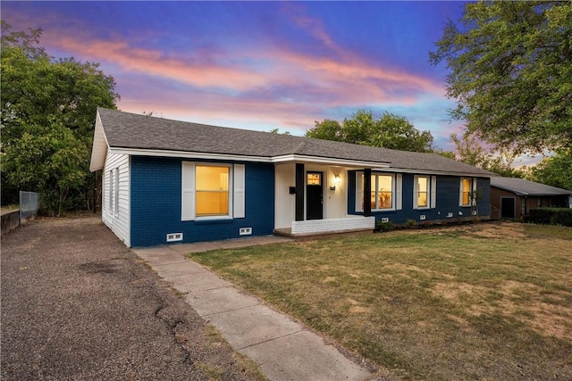 ranch-style house featuring a lawn