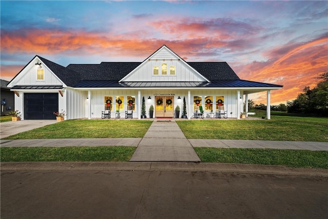 modern farmhouse style home with a porch and a yard