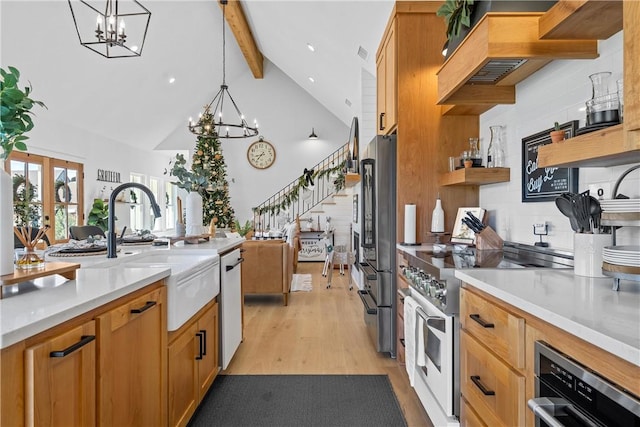 kitchen featuring french doors, hanging light fixtures, light hardwood / wood-style floors, beam ceiling, and stainless steel appliances