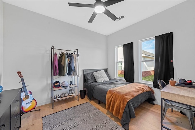 bedroom with light hardwood / wood-style flooring and ceiling fan