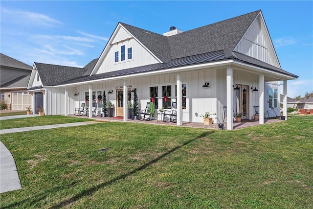 back of property with a porch and a yard