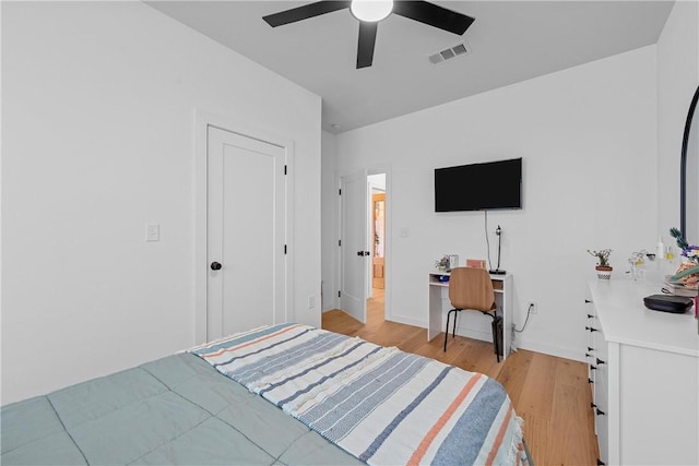 bedroom with light hardwood / wood-style flooring and ceiling fan