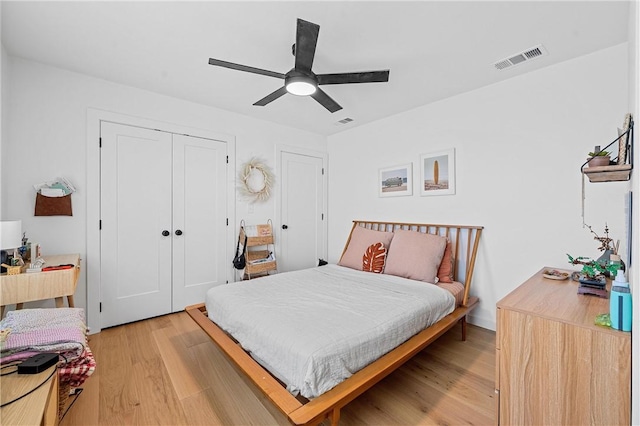 bedroom featuring ceiling fan, a closet, and light hardwood / wood-style flooring