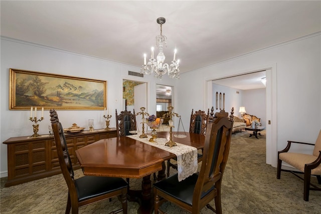 carpeted dining room featuring crown molding and a chandelier