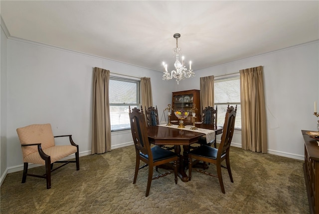 carpeted dining space with crown molding, a healthy amount of sunlight, and a notable chandelier