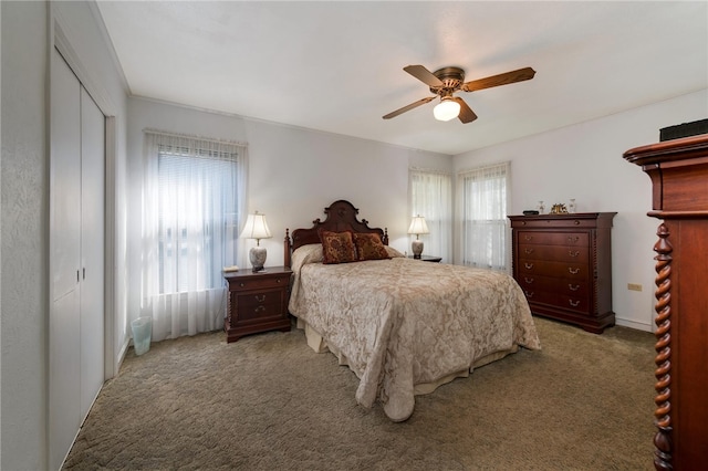 carpeted bedroom with ceiling fan and a closet