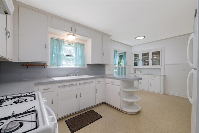 kitchen featuring white cabinetry, sink, and white range with gas stovetop