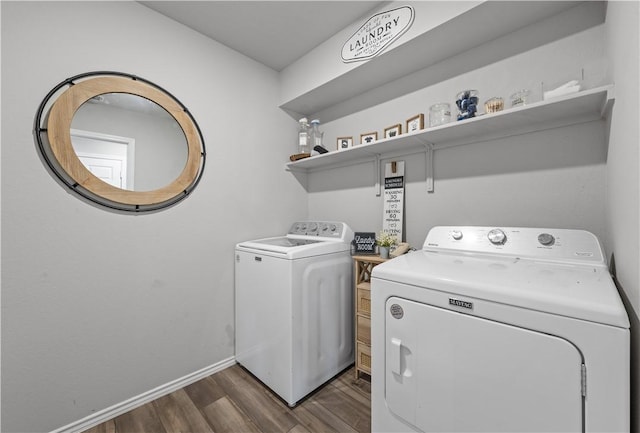 laundry room with washer and dryer and dark wood-type flooring