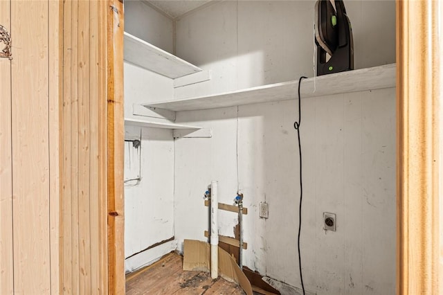 washroom with hardwood / wood-style flooring and electric dryer hookup