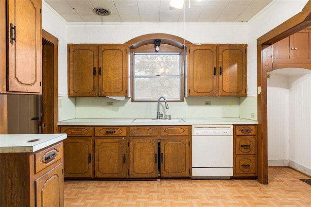 kitchen featuring dishwasher, light parquet flooring, crown molding, and sink