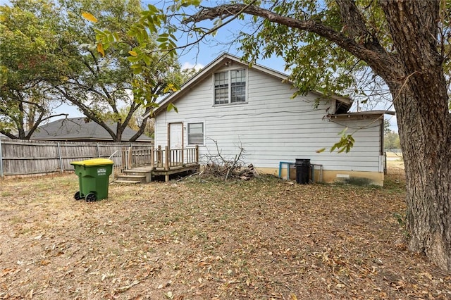 rear view of property with a wooden deck