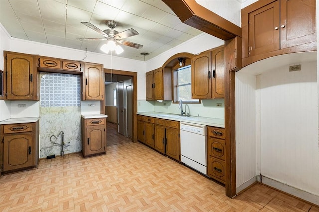 kitchen featuring ceiling fan, crown molding, sink, dishwasher, and light parquet flooring