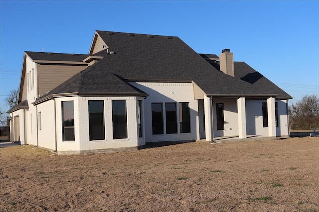 back of house with a yard and a patio area