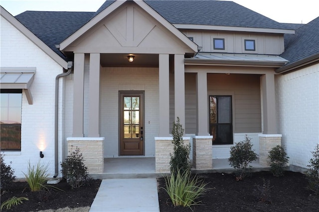 view of exterior entry featuring a porch