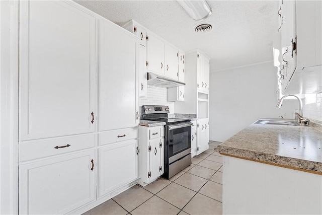 kitchen featuring sink, light tile patterned floors, white cabinets, and electric stove