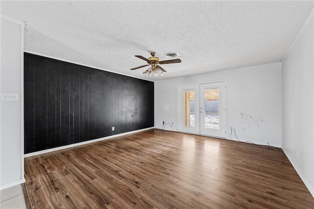 empty room with wood-type flooring, a textured ceiling, and ceiling fan