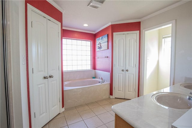 bathroom with tile patterned floors, vanity, crown molding, and a bath