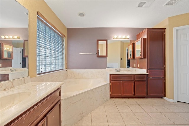 bathroom with tile patterned flooring, vanity, and a tub to relax in