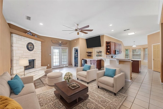 living room with ornamental molding and light tile patterned floors