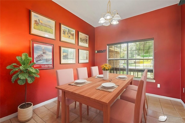 tiled dining space featuring a chandelier