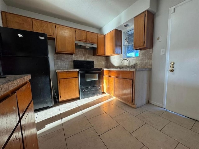 kitchen featuring black appliances, ventilation hood, light tile patterned floors, and brown cabinets