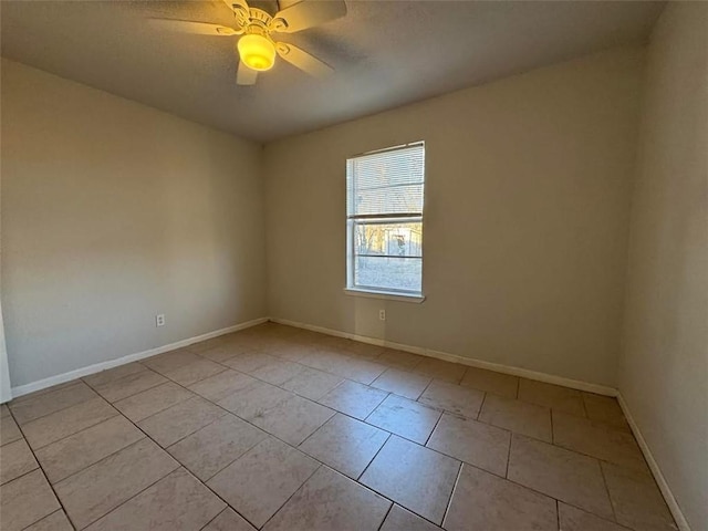 spare room featuring baseboards, a textured ceiling, ceiling fan, and tile patterned flooring