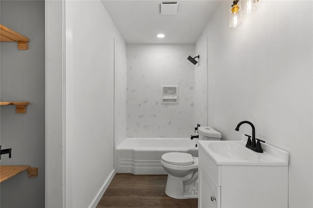 bathroom featuring vanity, bathtub / shower combination, wood finished floors, and toilet