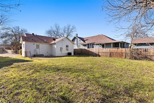 back of property featuring a yard, entry steps, fence, and central AC unit