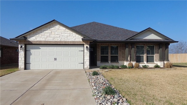 view of front of property with brick siding, concrete driveway, a front yard, stone siding, and an attached garage