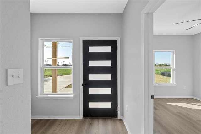 entrance foyer with ceiling fan and light hardwood / wood-style flooring