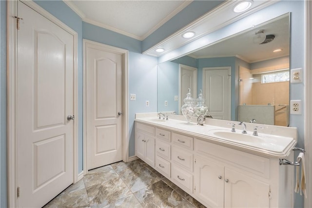 bathroom featuring crown molding and vanity