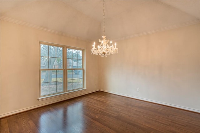 empty room with a notable chandelier, ornamental molding, and dark hardwood / wood-style floors