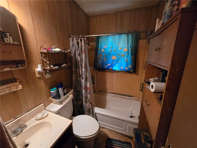 full bathroom featuring wooden walls, shower / bath combo with shower curtain, vanity, and toilet