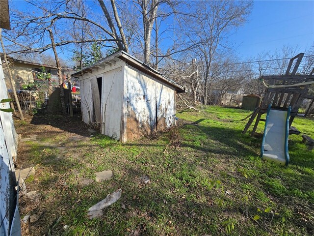 view of yard featuring a storage shed and a playground