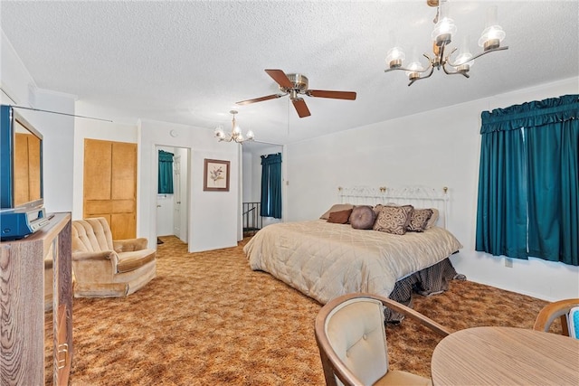 carpeted bedroom featuring ceiling fan with notable chandelier and a textured ceiling