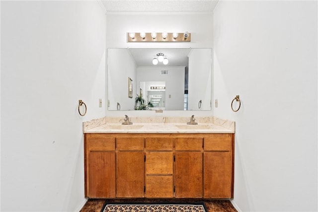 bathroom with vanity and ornamental molding