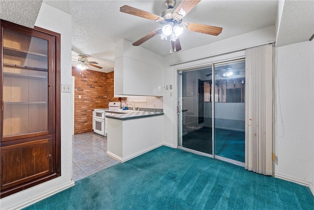 interior space with white cabinetry, white electric range, brick wall, a textured ceiling, and light carpet