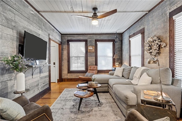 living room featuring ceiling fan, plenty of natural light, wood ceiling, and light wood-type flooring