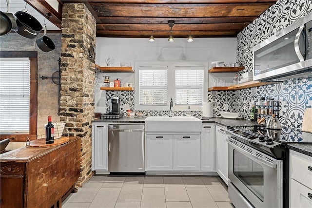 kitchen with white cabinets, stainless steel appliances, a wealth of natural light, and sink