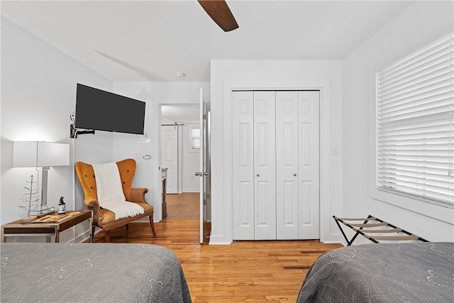 bedroom with ceiling fan, a closet, and light wood-type flooring