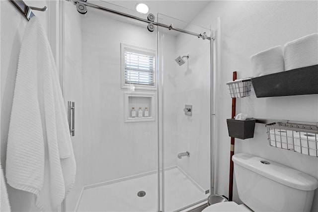 bathroom with toilet and walk in shower