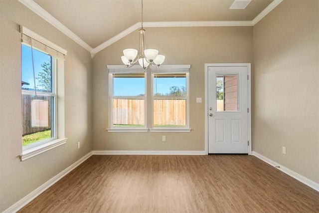 unfurnished dining area featuring lofted ceiling, wood-type flooring, ornamental molding, and a chandelier